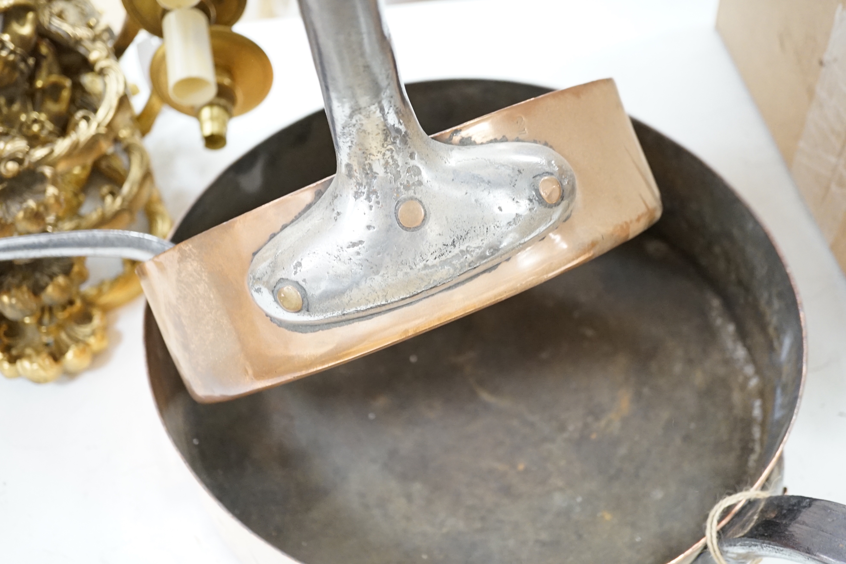 Three copper pans, largest diameter 35cm